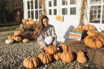 Woman on a harvest festival at pumpkin farm