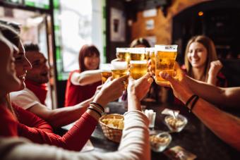 group of friends toasting at a bar