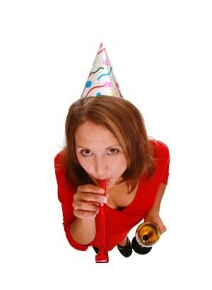 Woman with party hat and noisemaker