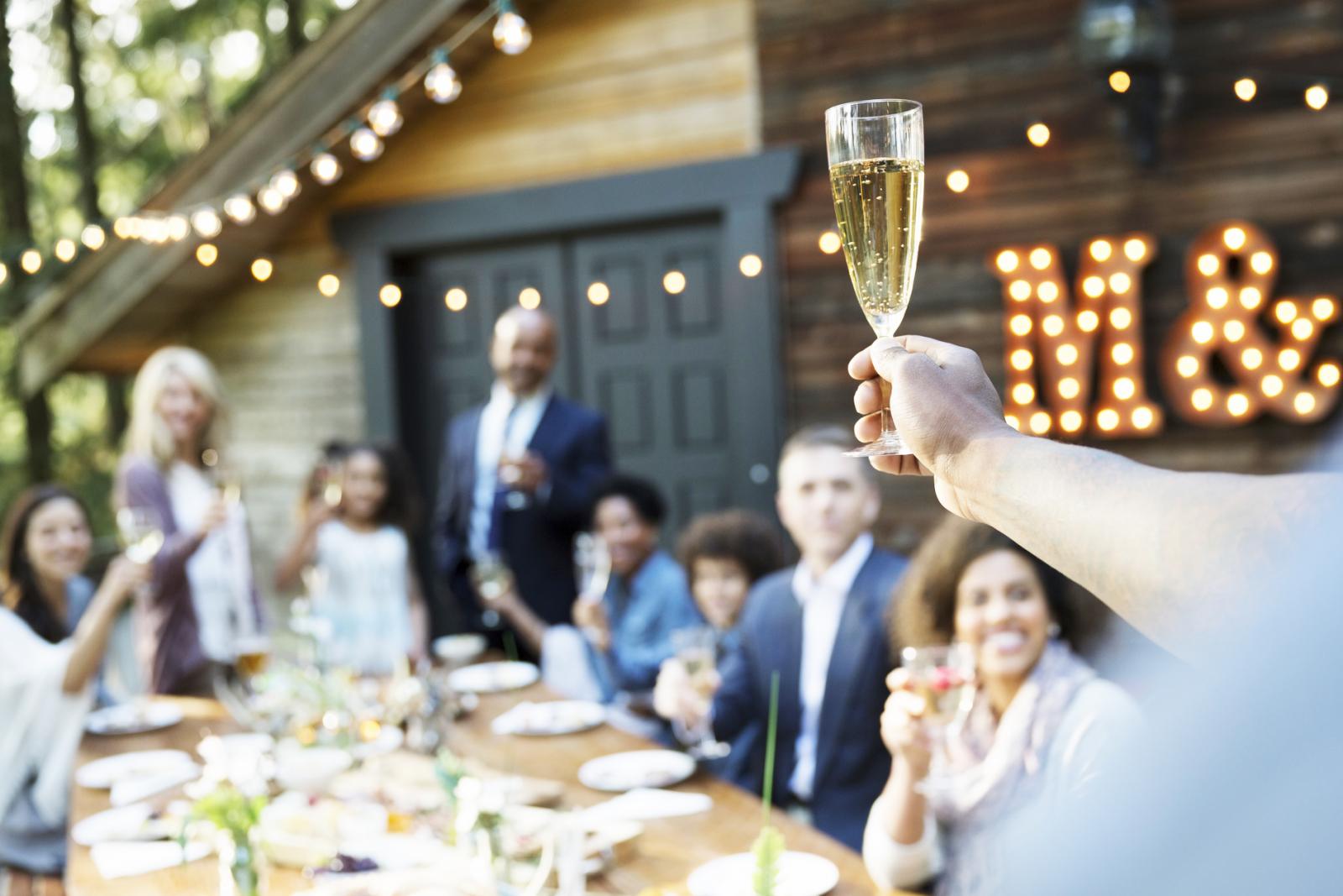 Man making a toast with his family