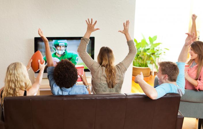Group of Friends Watching and Cheering Football Game