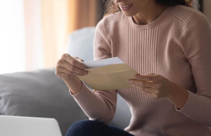 woman opening holiday invitation