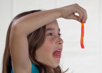 Child eating gummy worm