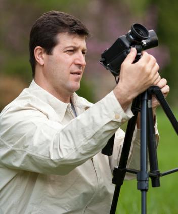 Man using a camera tripod