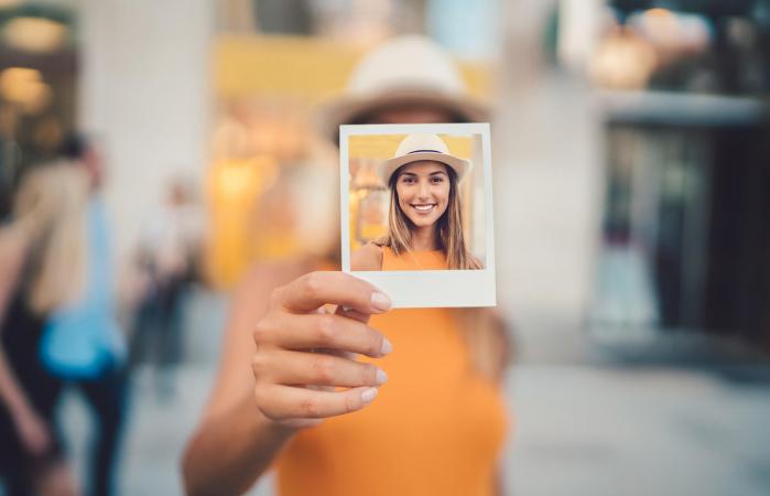 Woman showing polaroid