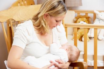 Mother Breastfeeding Her Baby After Breast Reduction Surgery