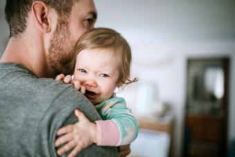 Father Holding Infant Sick With Cold Virus