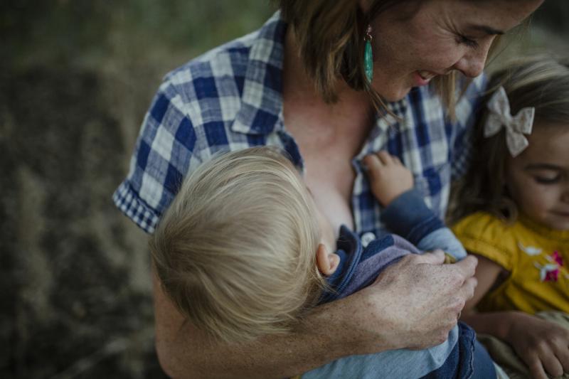 mother breastfeeding toddler son