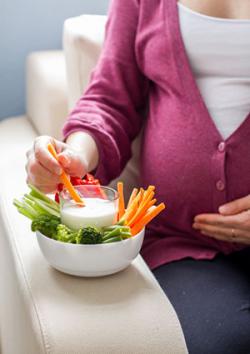 Pregnant woman having healthy snack