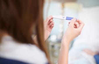 Woman holding a pregnancy test 