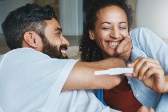 Shot of a happy couple celebrating their new pregnancy at home together