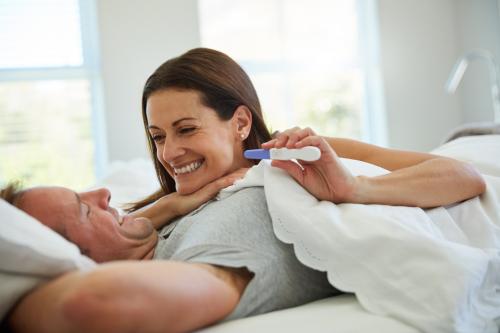 Couple smiling over a pregnancy test
