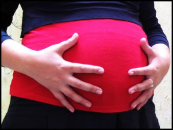 Pregnant woman holding her belly