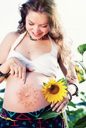 Pregnant woman pointing to belly design