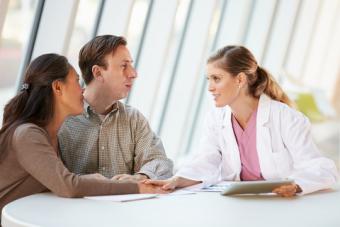 Couple talking to their fertility specialist