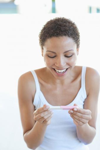Woman reading pregnancy test