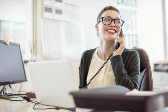 Businesswoman talking on landline phone