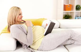 A woman writing in her pregnancy journal