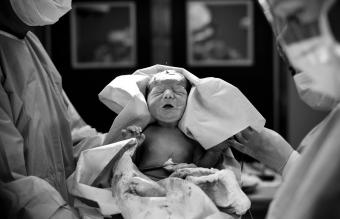 Doctors Carrying Newborn Baby