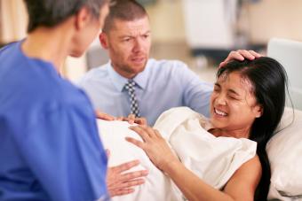 Woman giving birth with support