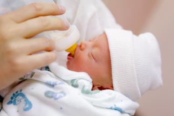 Mother bottle feeding her premature baby in the hospital nursery