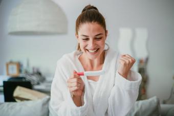 woman happy with pregnancy test results