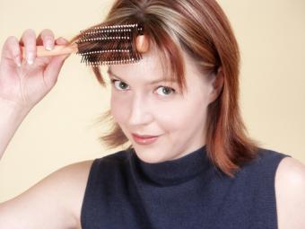 Woman using a round brush to create volume