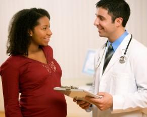 Pregnant woman consulting with doctor