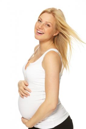 Happy woman who is 23 weeks pregnant
