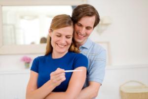 happy couple with pregnancy test