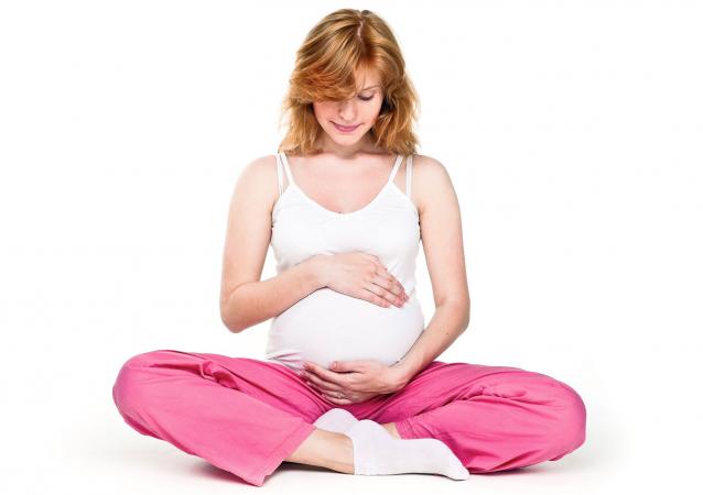 Pregnant woman cradling her belly