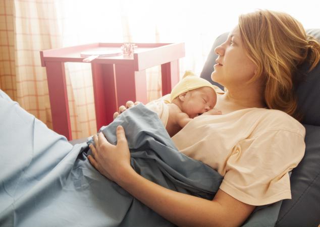 baby resting on mother's breasts