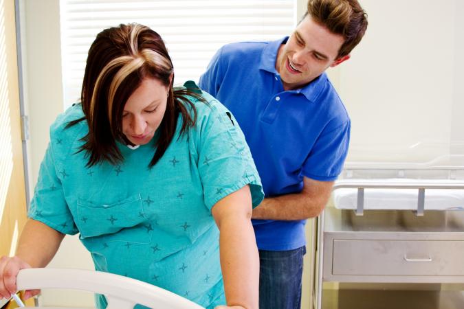 Husband with wife in labor