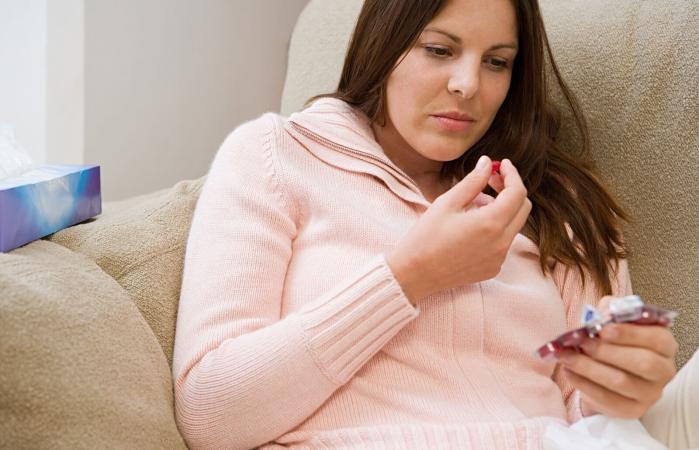 Woman taking a cough lozenge