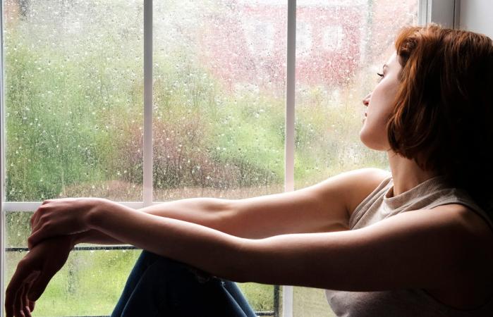Woman sitting near window