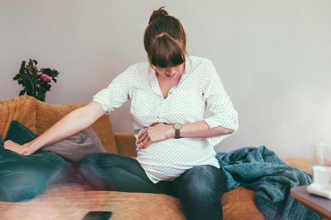 woman holding her pregnant belly