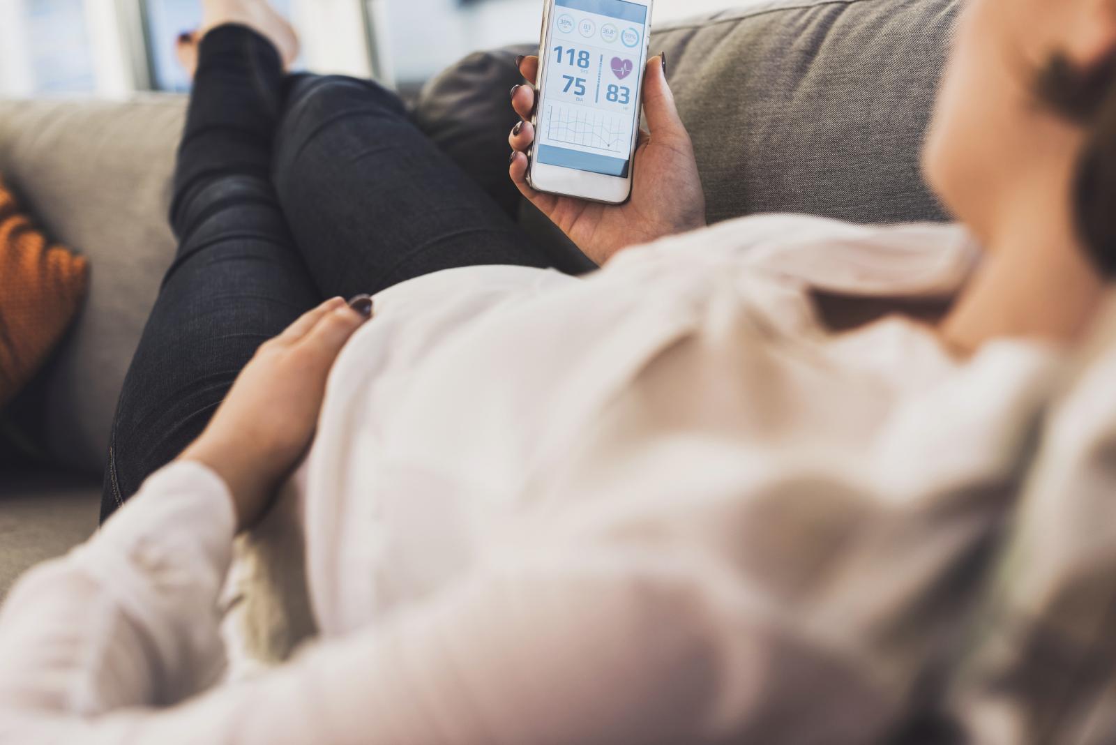 Pregnant woman using smartphone for health