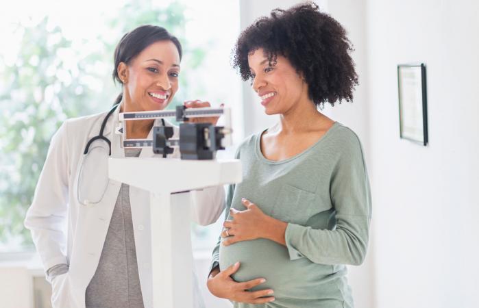 doctor weighing pregnant woman