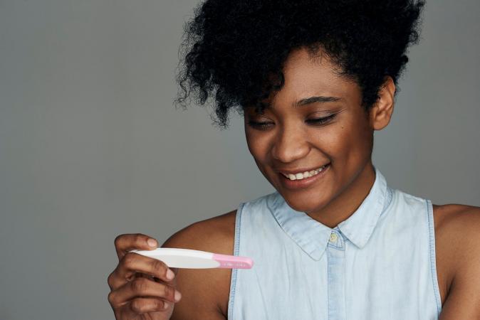 Woman looking at pregnancy test strip