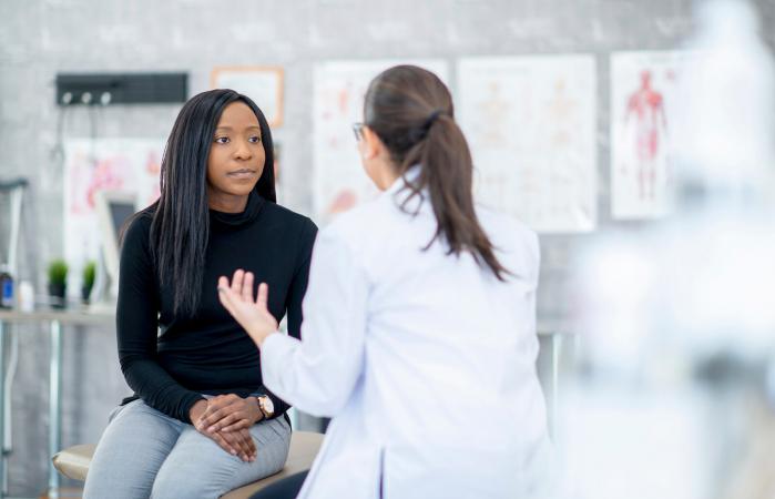 Young woman speaking with a doctor