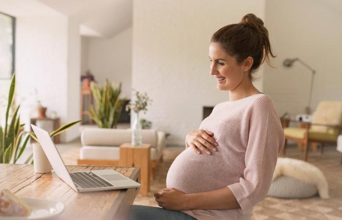Pregnant woman using her laptop