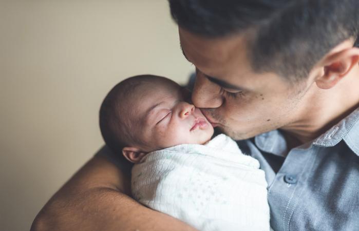 New Dad Holding Infant Daughter