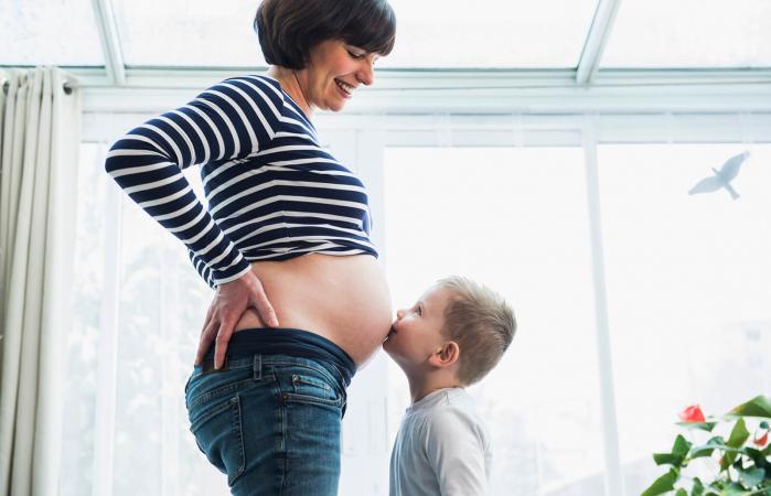 Pregnant woman wearing maternity jeans