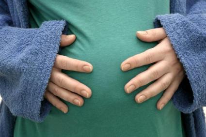 Pregnant woman hold hands on her belly
