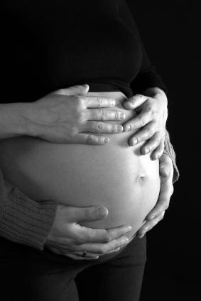 Black and white photo of pregnant belly