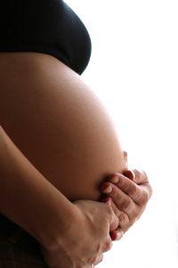 Pregnant mother holding her belly