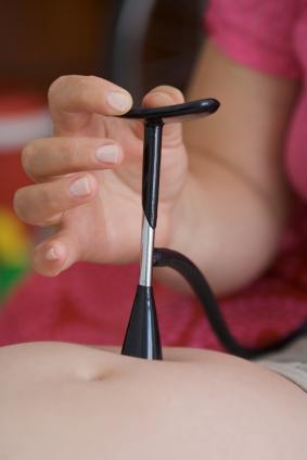 Midwife using a fetoscope