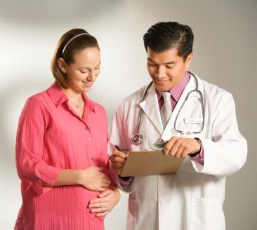 Prenant woman and her OB at a prenatal appointment