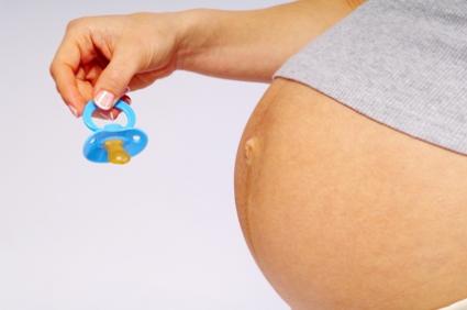 very pregnant woman enticing baby out