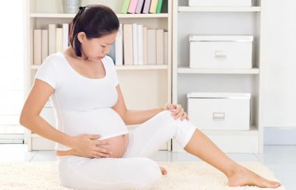 Pregnant Woman Touching Abdomen
